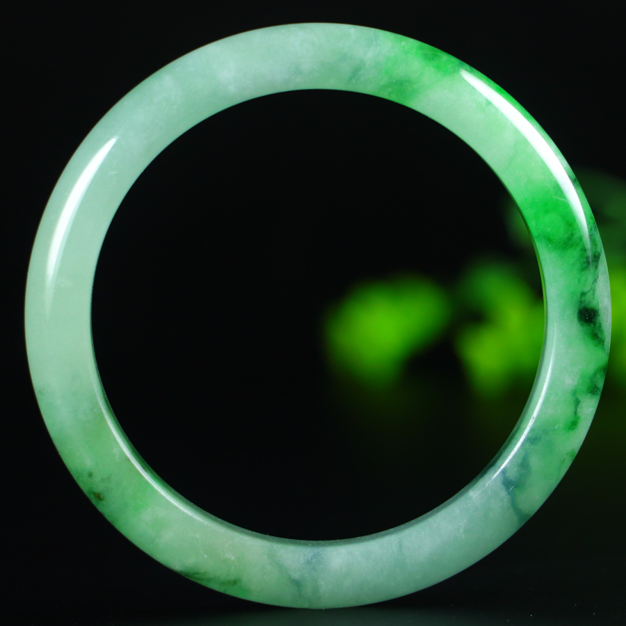 Jadeite bangle with icy green inclusions, 57.6mm in diameter.