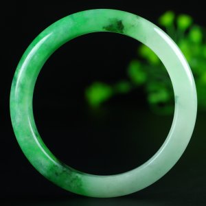 Jadeite bangle with icy green inclusions, 57.5mm in diameter.
