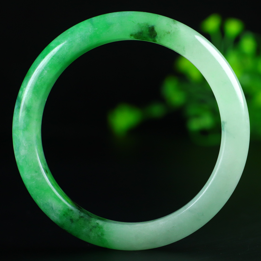 Jadeite bangle with icy green inclusions, 57.5mm in diameter.